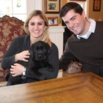 couple-holding-black-lab-puppy-endless-mt-labradors-akc-breeder-labrador-retriever-puppies
