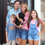 family-holding-black-lab-puppy-endless-mt-labradors-akc-breeder-labrador-retriever-puppies