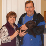 couple-holding-lab-puppy-endless-mt-labradors-akc-breeder-labrador-retriever-puppies